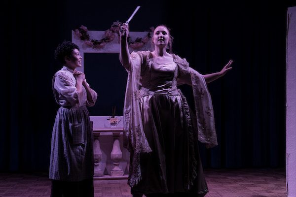 Two actors in period costume onstage